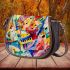 Abstract painting of musical notes and instruments saddle bag
