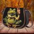 Adorable smiling green frog sitting saddle bag