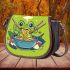 An adorable green frog eating ramen noodles saddle bag