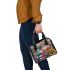 An intricate colorful painting shoulder handbag