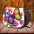 Beautiful butterfly with colorful wings among flowers saddle bag