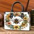 Bee in the center surrounded by flowers small handbag