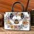 Bee in the center surrounded by flowers small handbag