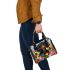 Black and tan dachshund dog surrounded by colorful tulips shoulder handbag