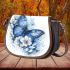 Blue butterfly with white flowers around saddle bag