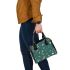 Butterflies and flowers scattered across shoulder handbag