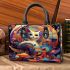 Colorful cat amid abstract shapes small handbag