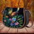 Colorful glowing butterfly surrounded by flowers and leaves saddle bag