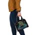 Colorful green frog playing banjo under mushroom shoulder handbag