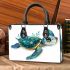 Cute baby turtle in the ocean small handbag