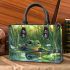 Cute baby turtle in the water small handbag