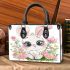 Cute cartoon bunny with big eyes sitting on the flowers small handbag