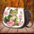 Cute cartoon frog sitting on the ground with pink flowers saddle bag