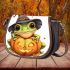 Cute cartoon frog wearing a witch hat sitting on a pumpkin saddle bag