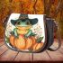 Cute cartoon frog wearing a witch's hat sitting on a pumpkin saddle bag