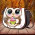 Cute cartoon owl with leopard headband holding saddle bag