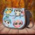 Cute cartoon owls with cute hats sitting on tree branches saddle bag