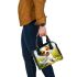 Cute cartoon puppy sitting on the grass shoulder handbag