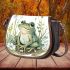 Cute frog sitting on the ground with flowers saddle bag