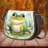 Cute frog sitting on the ground with flowers saddle bag