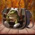 Cute green frog sitting in an armchair wearing white bunny slippers saddle bag