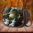 Cute green frog sitting in an armchair wearing white bunny slippers saddle bag