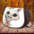 Cute happy white rabbit with big eyes holding one carrot saddle bag