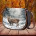 Cute little deer standing in the snow saddle bag