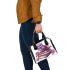 Cute purple owl sitting on top of books surrounded shoulder handbag