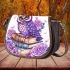 Cute purple owl sitting on top of books surrounded by pink roses saddle bag