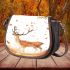 Deer with falling leaves in an autumn forest saddle bag