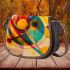 Dynamic composition of geometric shapes and colorful lines saddle bag