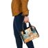 Elegant deer standing amidst autumn foliage shoulder handbag