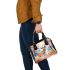 Elegant deer standing amidst autumn foliage shoulder handbag