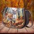 Elegant deer standing amidst autumn foliage saddle bag