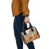 Elegant deer standing amidst autumn foliage shoulder handbag