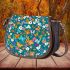 Flowers and butterflies in shades of orange saddle bag