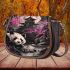Giant panda under the moon surrounded by pink cherry blossom trees saddle bag
