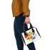 Incorporating elements like geometric shapes shoulder handbag