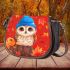 Owl wearing blue hat sitting on wood saddle bag