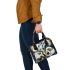 Painting of calla lilies in bold geometric shapes shoulder handbag