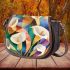 Painting of calla lilies in geometric shapes and forms saddle bag