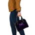 Purple frog with bright green eyes and on a solid shoulder handbag