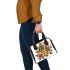 Queen bee sitting on top of honeycomb shoulder handbag