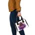 Queen bee with a crown sitting on flower shoulder handbag