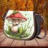 Red and white mushroom with green frog sitting on it saddle bag