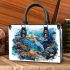 Turtle swimming among coral reefs small handbag