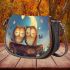 Two cute cartoon owls sitting on a log in love saddle bag