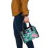 Vibrant pattern of pink and turquoise butterflies shoulder handbag