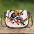 Abstract composition of colorful circles and lines saddle bag